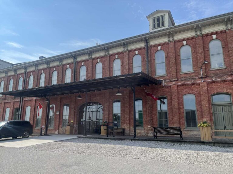Entrance of the historic CASO railway station in St. Thomas with CASO Station 750 Talbot Street lettering above the doors, canopy and benches