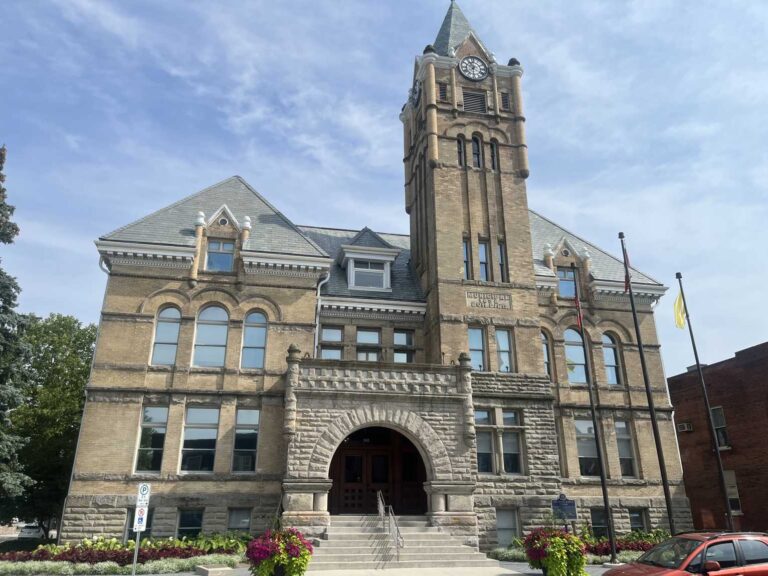 St. Thomas City Hall municipal building with clock tower and stone archway entrance on a sunny day