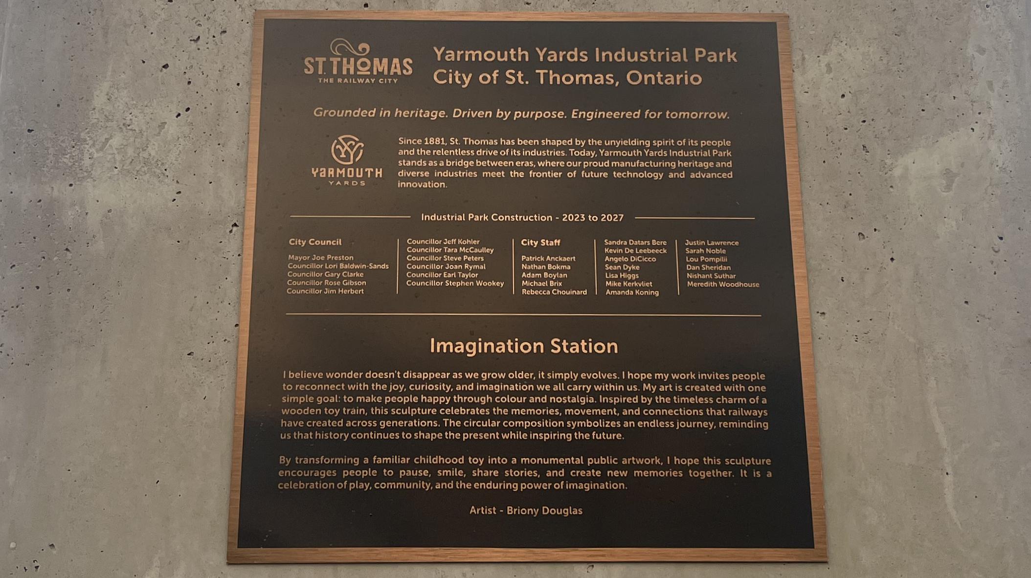 The dedication plaque at the base of Imagination Station, with the artist's statement.