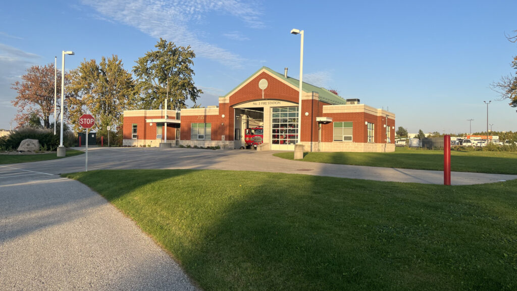 The red-brick St. Thomas No. 2 Fire Station at 235 Burwell Road in evening light, a fire truck visible in the open bay