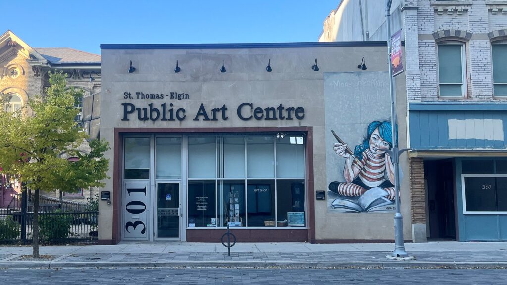 Front of the St. Thomas-Elgin Public Art Centre at 301 Talbot Street in St. Thomas, with its Make Your Mark mural, seen from across Talbot Street on a sunny autumn afternoon